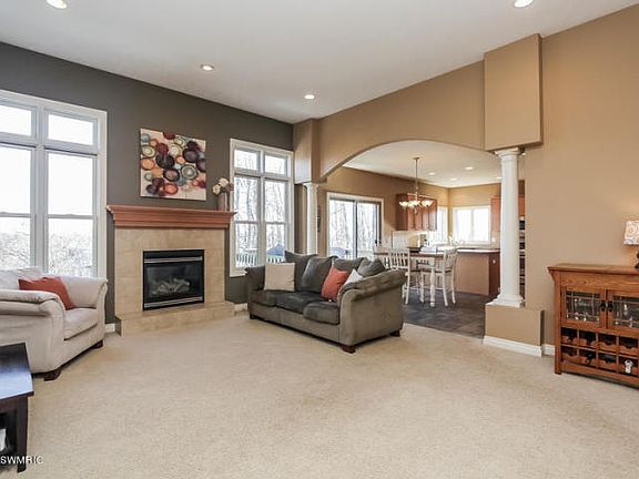 IMPRESSIVE GREAT ROOM W/ SOARING 12FT CEILINGS, GAS FIREPLACE, TALL INSULATED ANDERSON WINDOWS,& COLUMNS & ARCHES. ROUNDED CORNERS & RECESSED LIGHTS W/ DIMMERS THROUGHOUT.