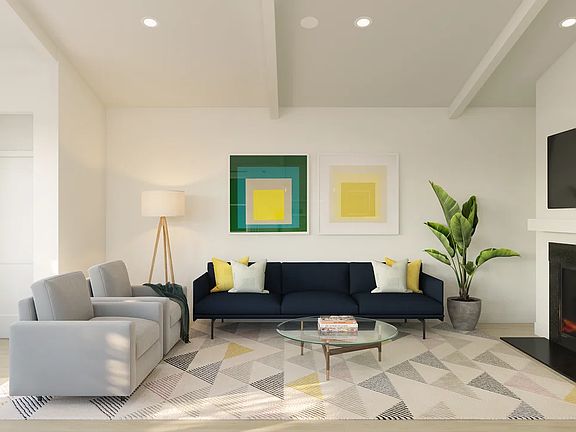 Great room with vaulted ceiling and white-stained ceiling beams