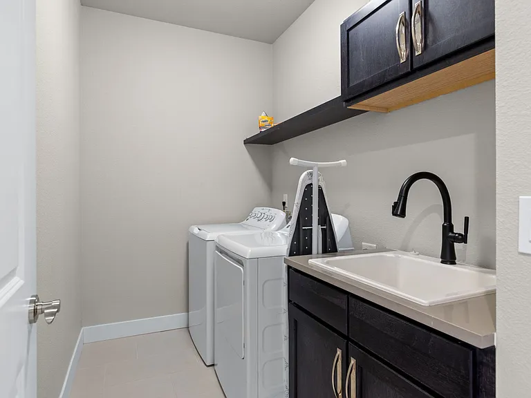 Laundry room with washer/dryer, sink