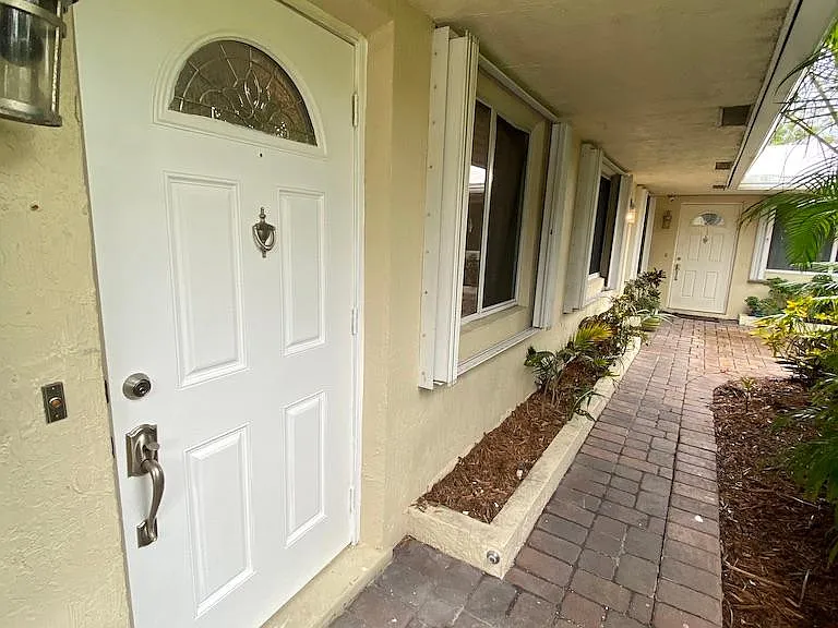 West facing view of Front door entry taken from Parking lot area