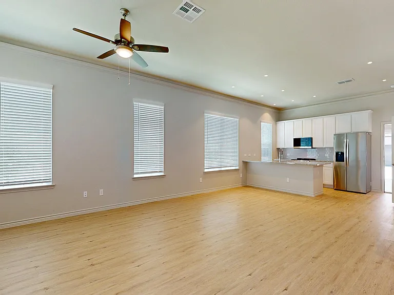 Open Concept Living, Dining, and Kitchen with Crown Molding