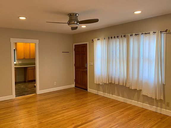 Living Room with beautiful hardwood flooring modern ceiling fan.