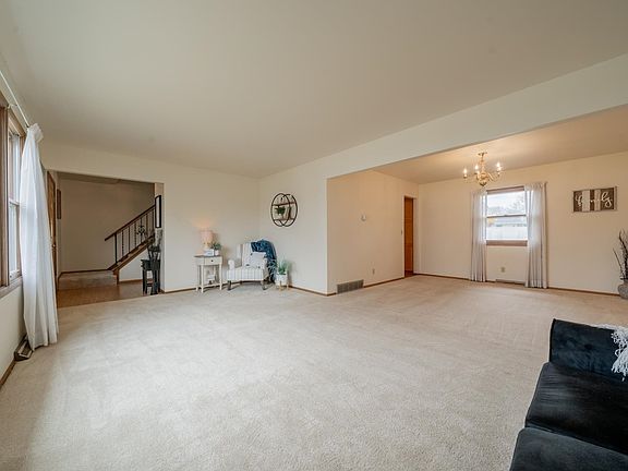 SPACIOUS LIVING ROOM IS OPEN TO THE DINING ROOM