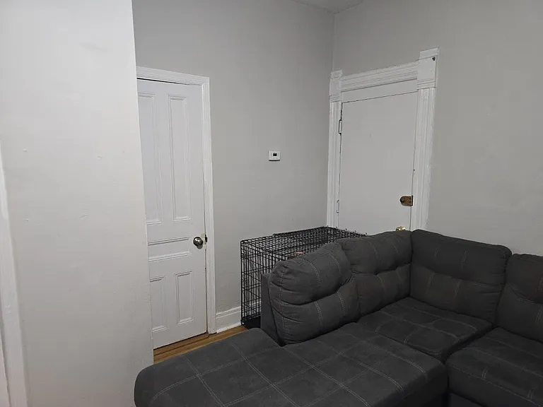 View of bathroom door and door into common hallway (back exit).