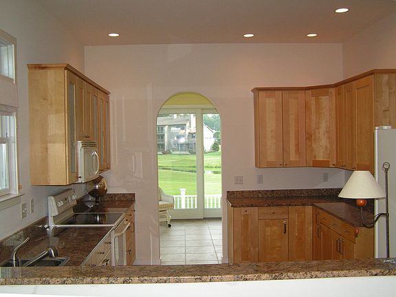 Lovely kitchen with Granite Counters, Custom Cabinets & Tile Floor