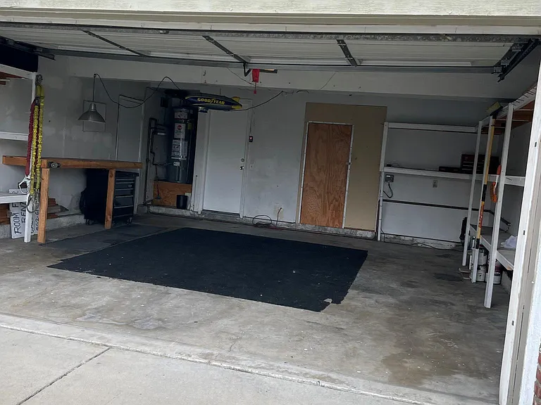 Two car garage with a lot of shelves and storage