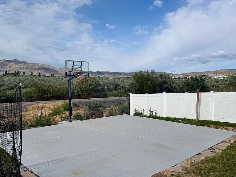 25X30 Ft basketball court with adjustable hoop.