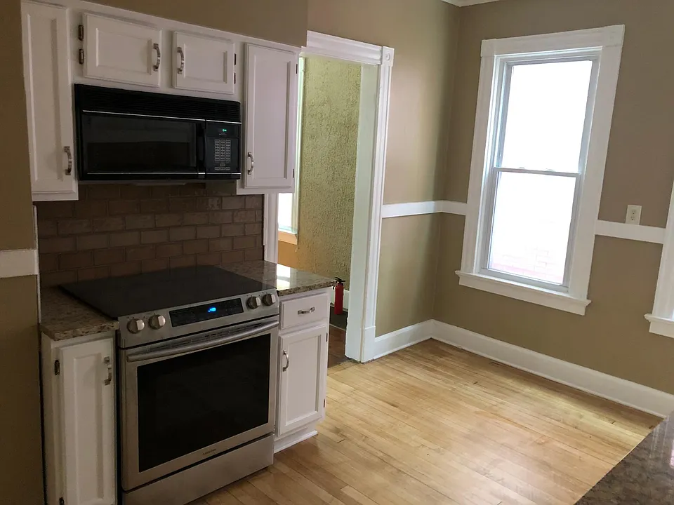 Newly re-done kitchen with hardwood floors and granite countertops.