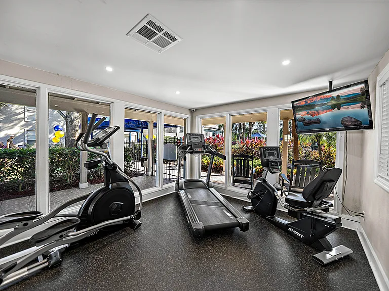 Community fitness center with cardio machines and natural light