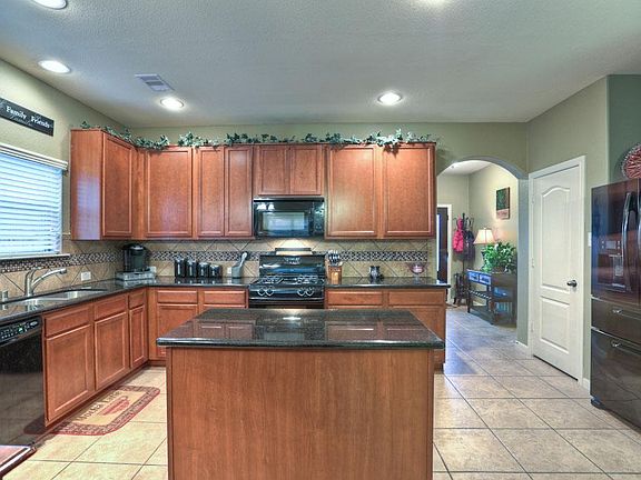 Kitchen with tile floors and backsplash
