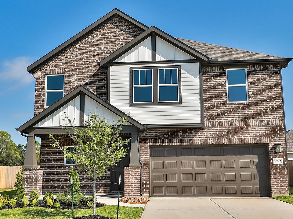 Experience luxury at Ellis Cove with a two-story brick facade, elegant gable roof, and meticulously
