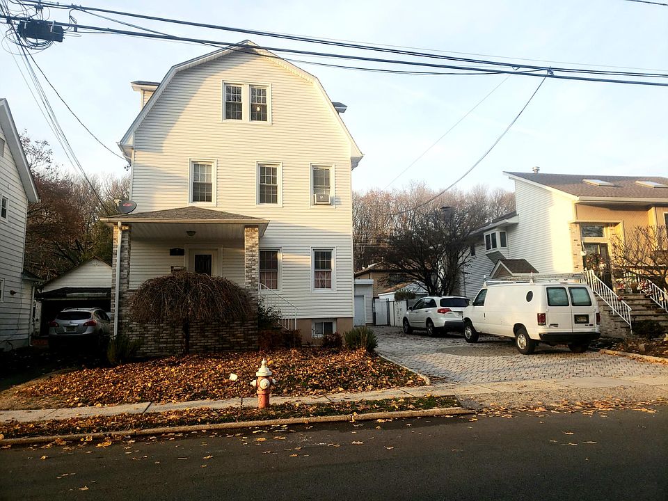 Front of house and driveway on right with two parking spots for tenants. Plenty of on street parking as well.