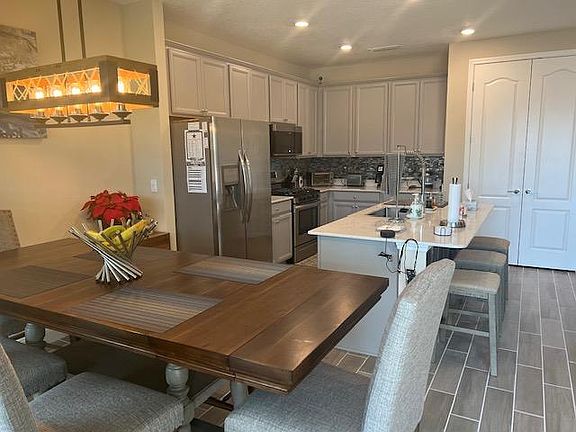 Large kitchen cabinets and double door pantry with plenty of storage. Large island with under-mount sink.