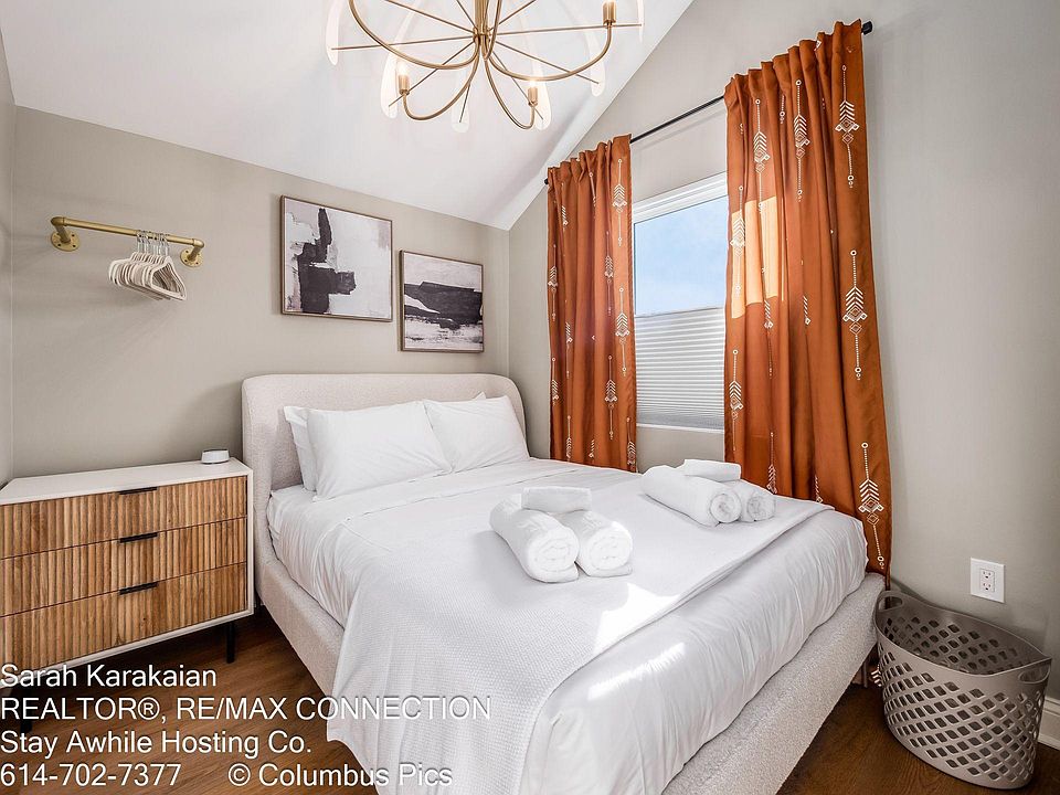 The smaller of the two bedrooms has a queen bed with a Helix mattress and blackout blinds.