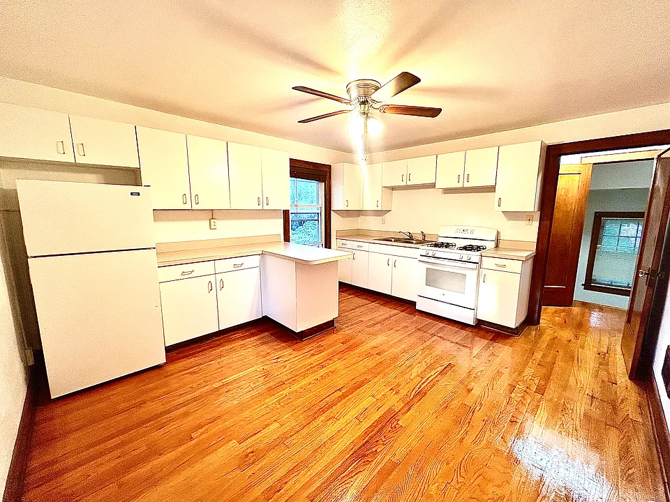 Oversized kitchen with plenty of space for a good sized table and one or two bar stools. Gas stove.