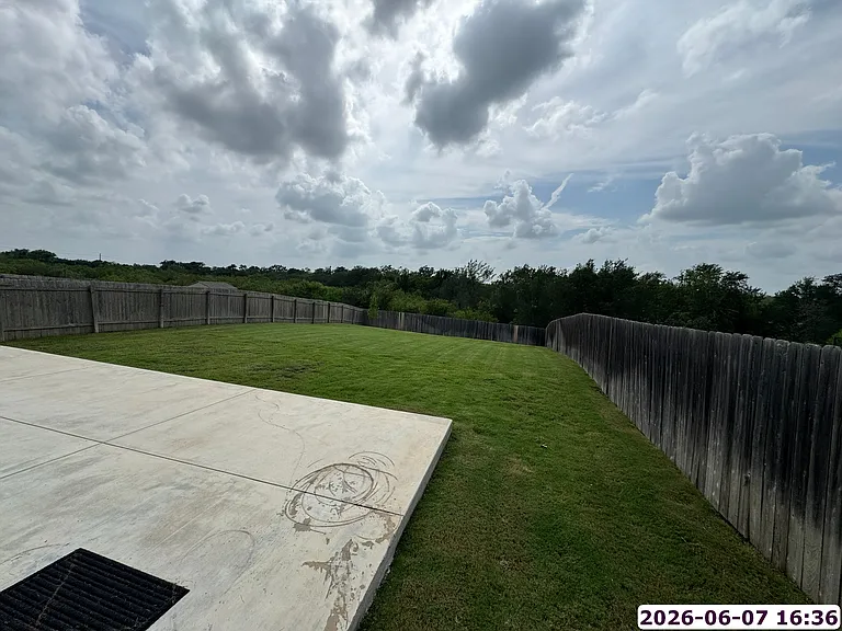 35' x 15' patio overlooking a large backyard with greenbelt behind.