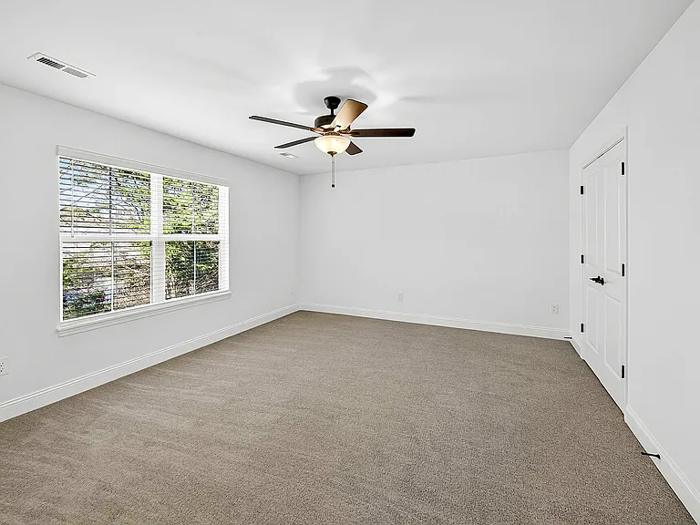 Primary bedroom with ceiling fan
