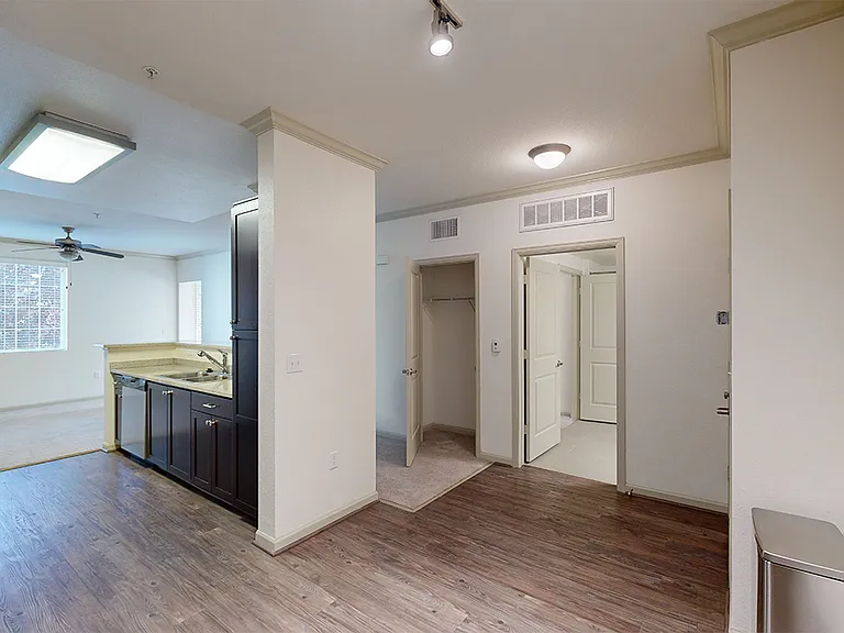 Apartment dining room with wood-style flooring.