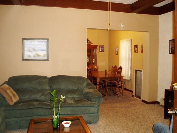 LIVING room, with high ceiling with beams