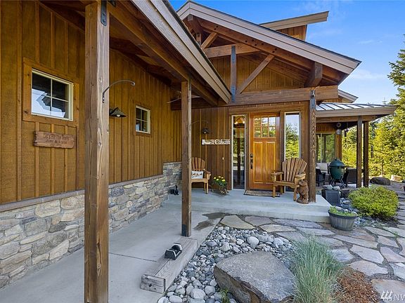 All the perfect elements of excellent NW lodge architecture & style are here.....all wood siding w/rock accents, stone patio, timber frame construction, metal & comp roof.
