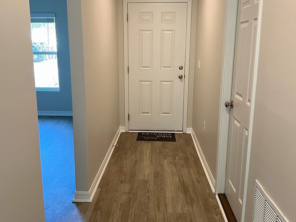 Entry and hallway. Garage door is on the right and front bedroom/bath are on the left.