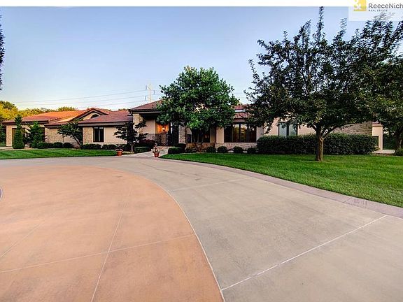 Newer driveway offers access to the front door as well as to both sides of the home where you will find garage access....3+ car on the West side of the home and 6+ on the far East side of the home. (new owner could add car lifts in this garage)