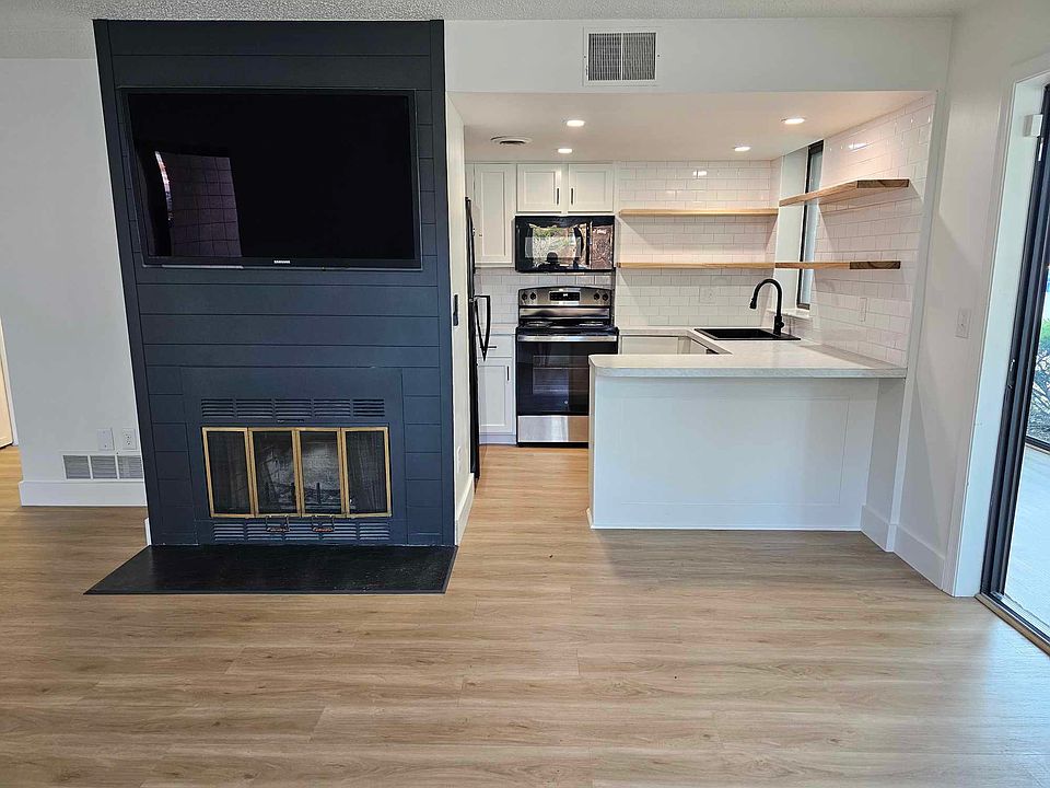 Modern Kitchen with a sit in bar feature the gorgeous accent fire place.