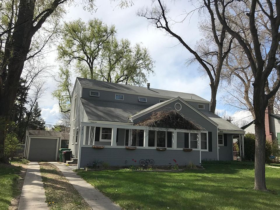 Front of 2817 in spring, off street parking is for this unit. Peonies, grape vine, front porch.