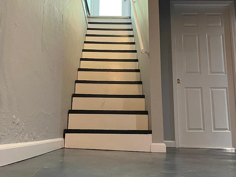 Stairs leading to fully finished lower level