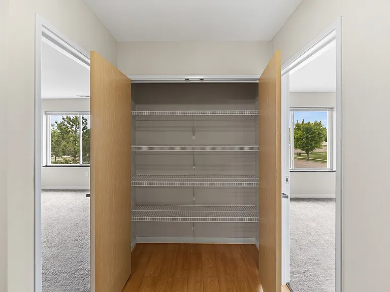 Maximize your storage potential with this spacious pantry at Overlook Ridge. Featuring ample shelving and a bright, airy feel, this space is perfect for organizing your essentials. Explore how Overlook Ridge can elevate your lifestyle today!