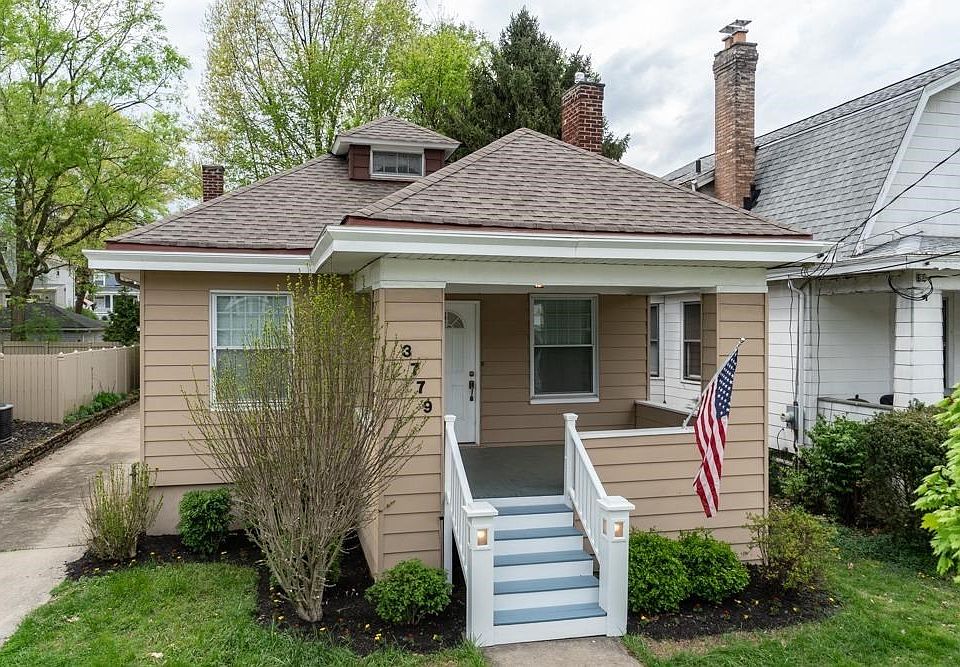 Adorable Cape Cod with covered front porch, built in stair lighting, hard wood floors and plenty of parking