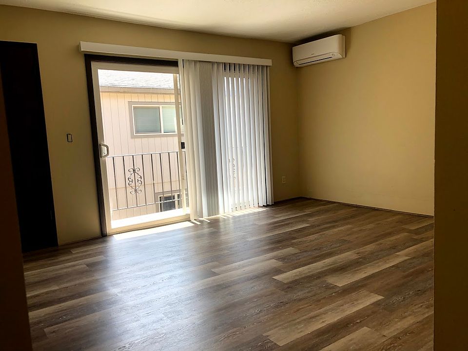 Large living room area, A/C & heating unit, & private balcony