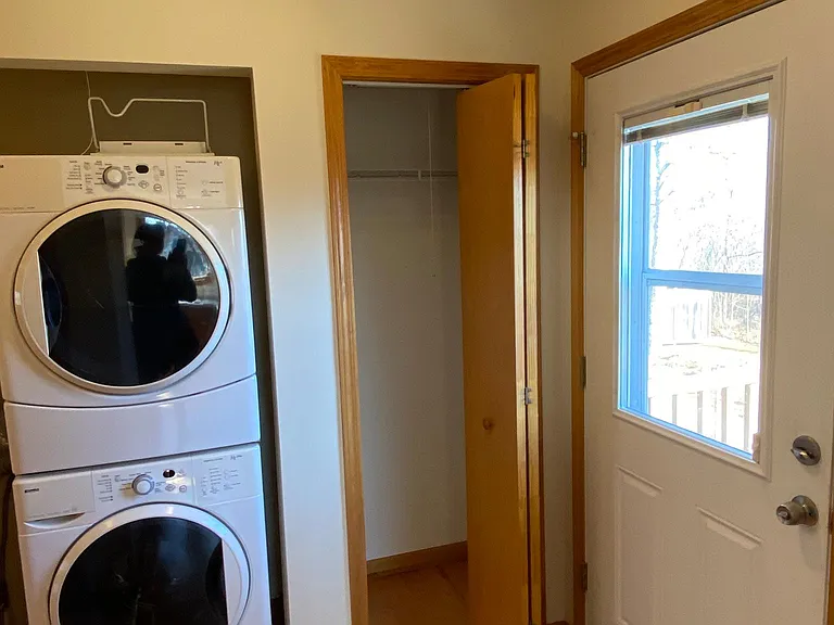 Upstairs laundry room, back door, broom closet