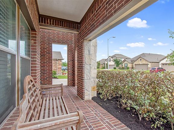 "Popular KB Home" with an Oversize porch, Brick, Stone and Shutters front elevation