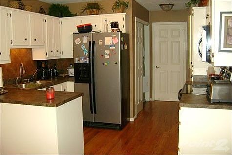 Kitchen was updated 2 years ago with new hardwood floors, countertops, tiled backsplash, paint & sta