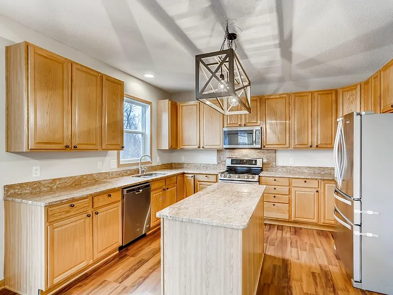 Kitchen with granite countertops and stainless steel appliances.