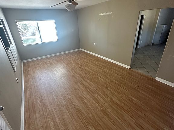 Main Living Room upon entrance to the house, fan will be replaced and all walls are being painted white.