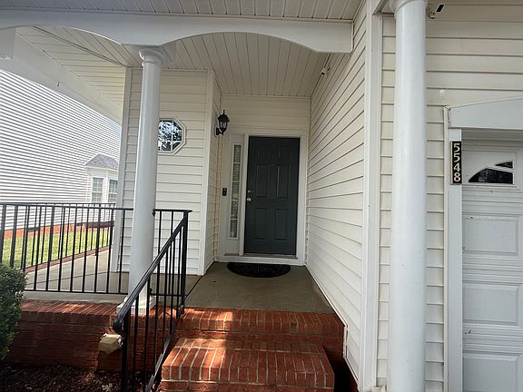 End unit with wrap around porch.