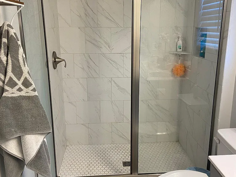 Master bedroom full bathroom with shower and upgraded tile (and shelves)