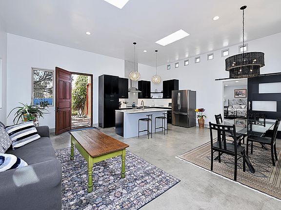 Open the front door to this large, 11 foot ceiling, light-filled kitchen, living, dining and back door opening to back patio, owner residence.