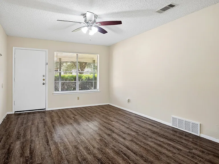 Another view of the living room with wood floors