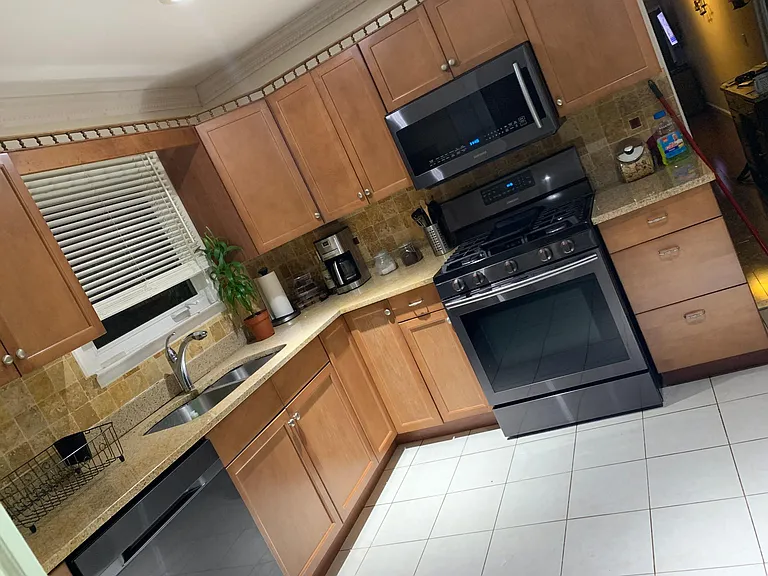 Beautiful Kitchen with black stainless steel appliance.