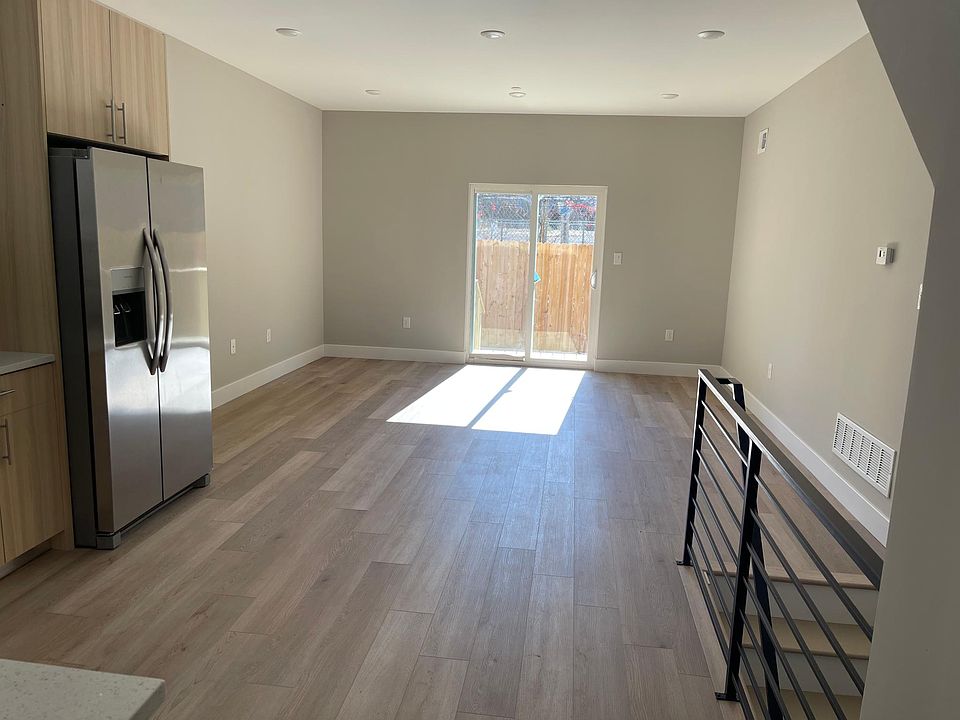 kitchen, living and dining area with sliding glass doors to the back yard