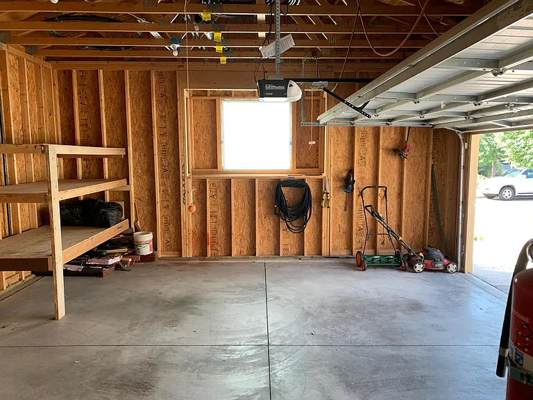 Garage has automatic opener and large window with privacy film.