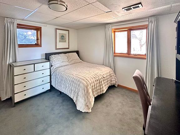 Master bedroom with full-size desk and hutch. Over 6 ft of closet space.