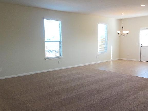 SPACIOUS FAMILY ROOM OVERLOOKING THE DINING AREA AND KITCHEN
