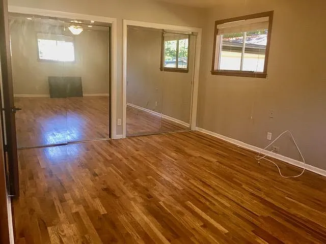 Solid wood floors in master bedroom.