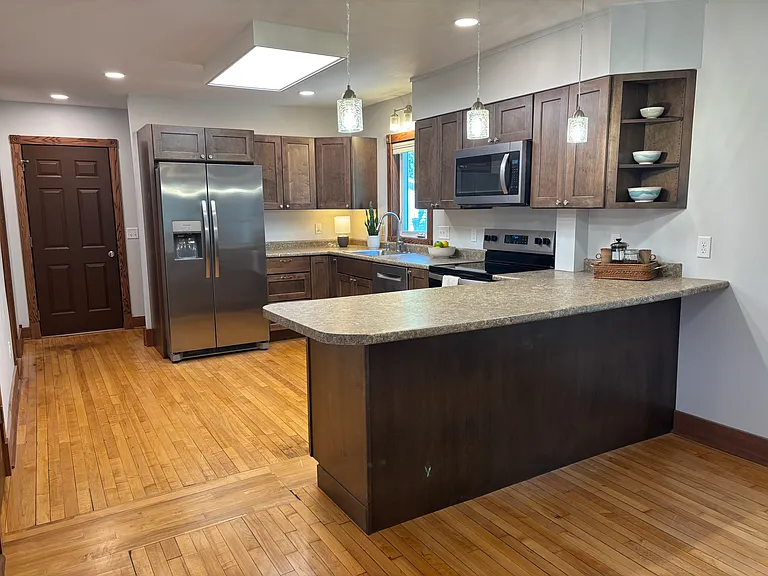 Open plan kitchen with wood floors