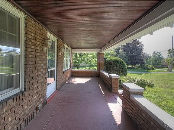 Great porch for storm-watching!  Protected from the elements, there's plenty of room for a porch swing, table and chairs to enjo