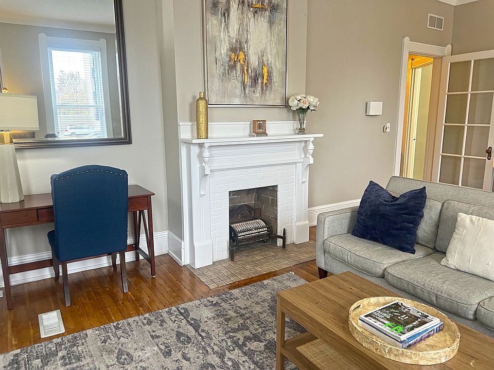 Living room fireplace, door leads to beautiful foyer.
